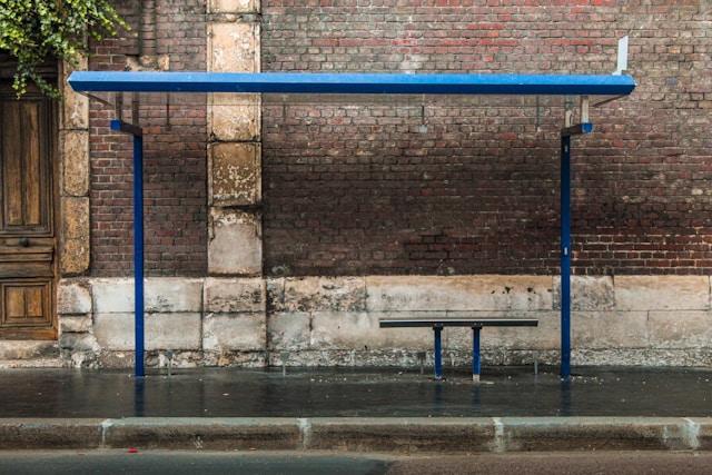 Empty blue bus stop in the rain